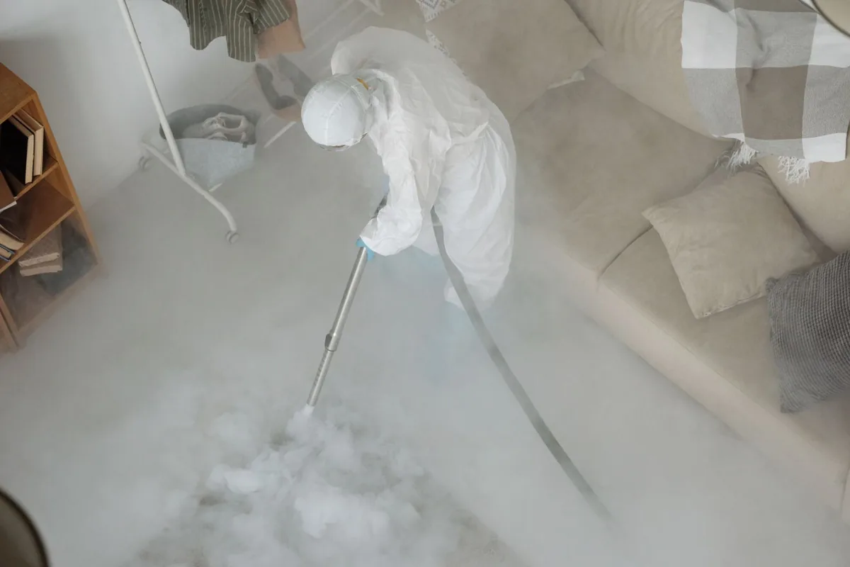 Biohazard cleanup technician in protective equipment, Ballinger, TX